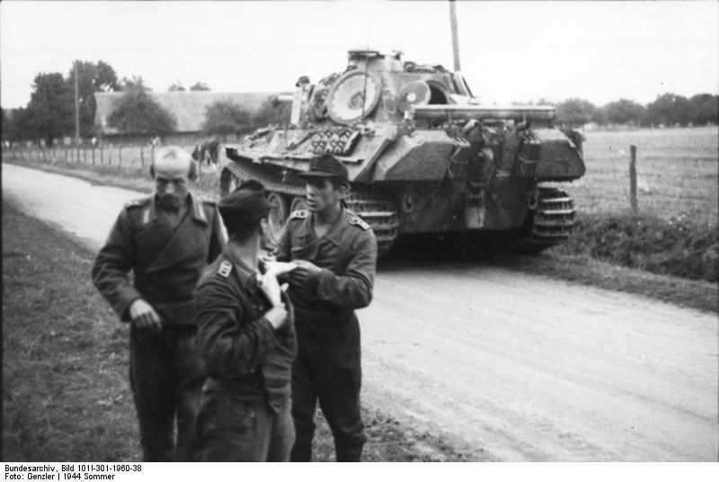 A Panther tank and three crewmen on a country road in Northern France, 1944
