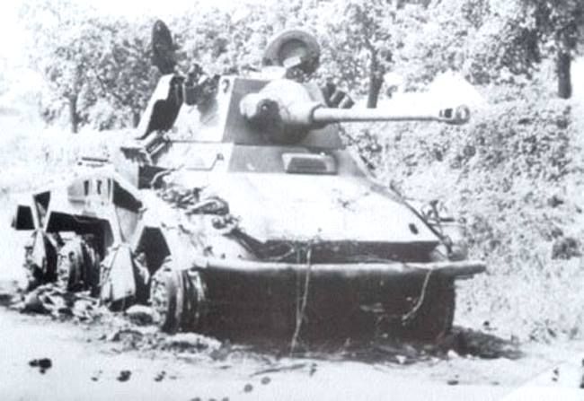 A burnt-out Panzer Lehr Puma armoured car at the roadside