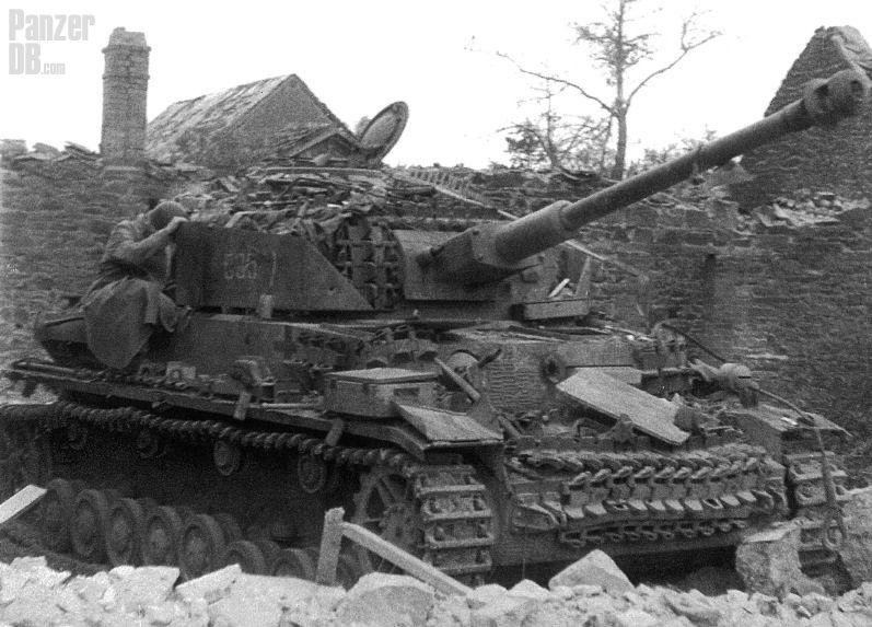 A destroyed Panzer IV among ruined buildings