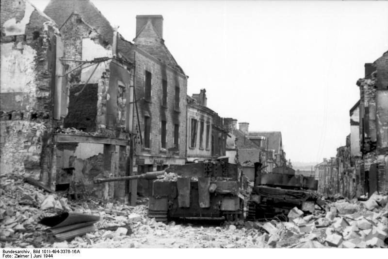 A ruined street in Villers-Bocage with a tank among the rubble