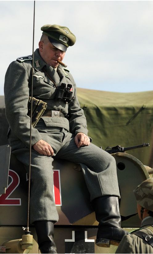 An officer seated on the hull of a tank