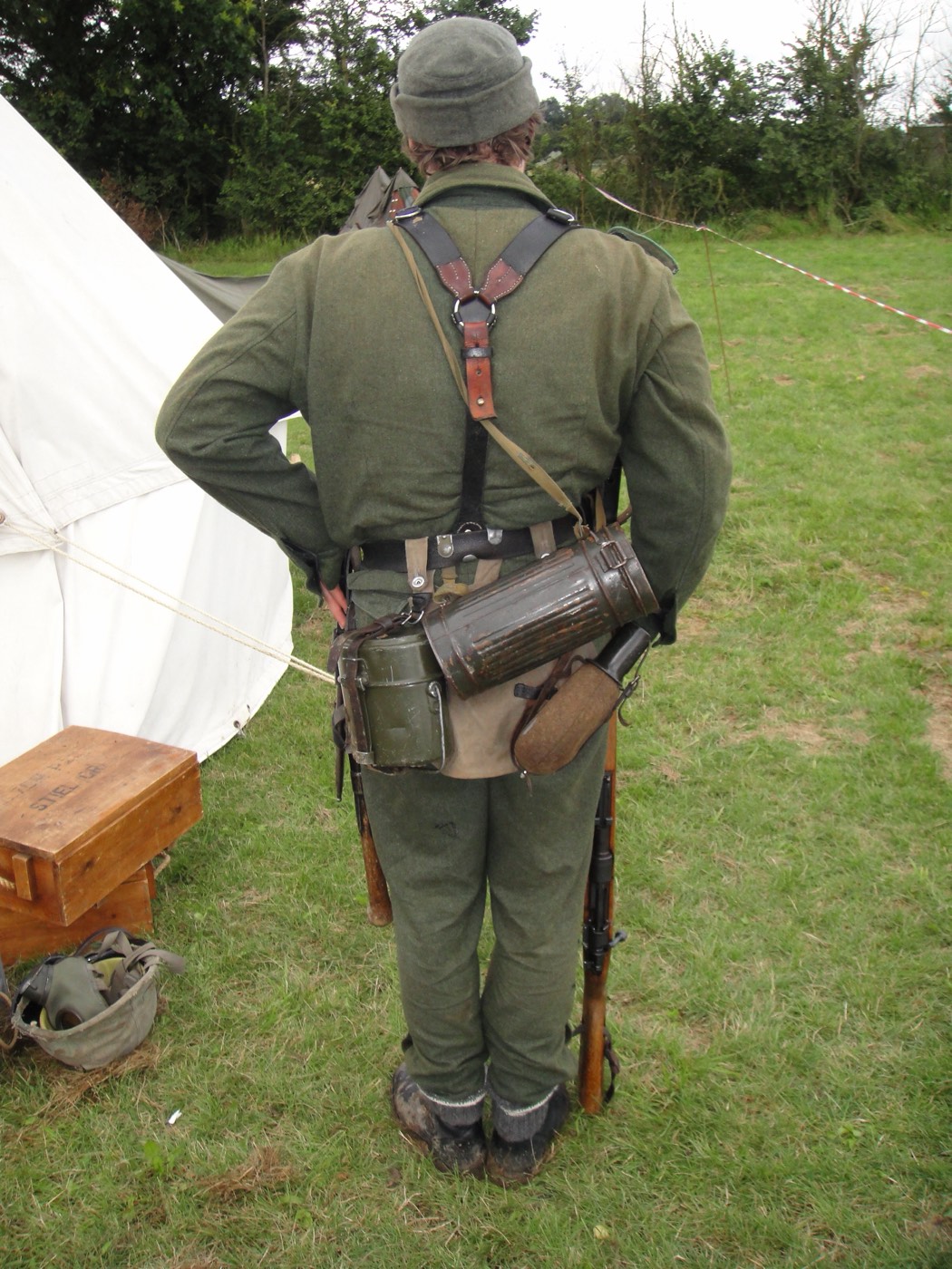 The same member seen from behind, showing the field gear worn on the belt